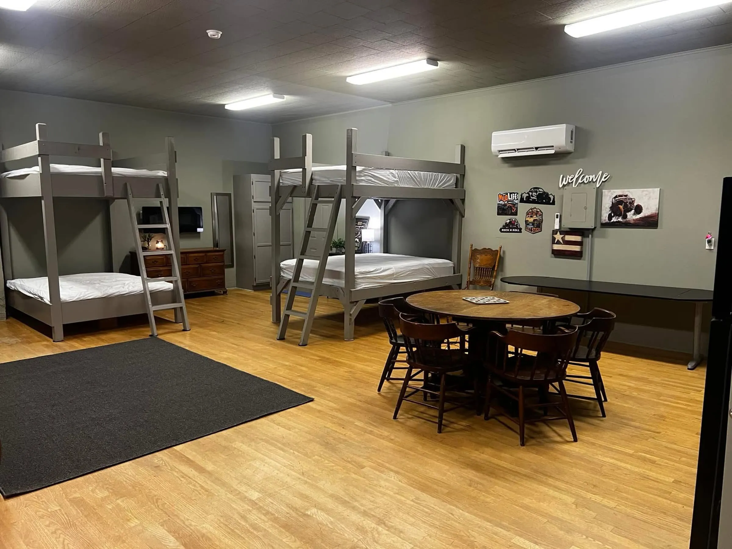 Inside the Bunkhouse, with queen-over-queen bunk beds and a dining table