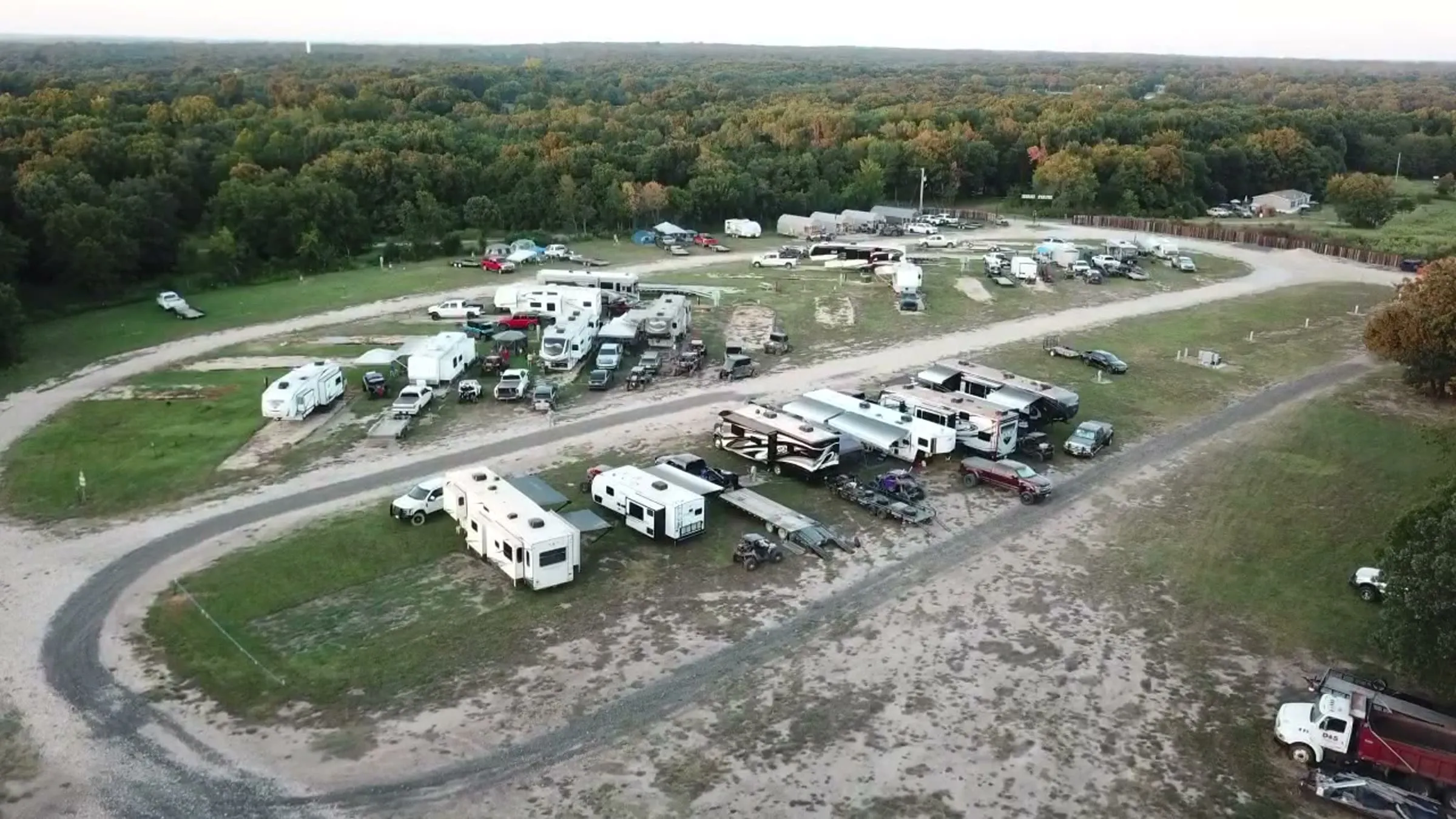 Aerial view of the campground loop with RVs and trailers parked among the trees